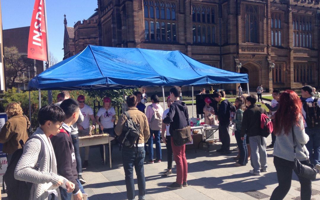 A group of university students attending an information stall about organ and tissue donation awareness